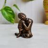 eCraftIndia Resting Buddha on Knee Polyresin Statue (5 cm x 5 cm x 7.5 cm, Brown) view 1