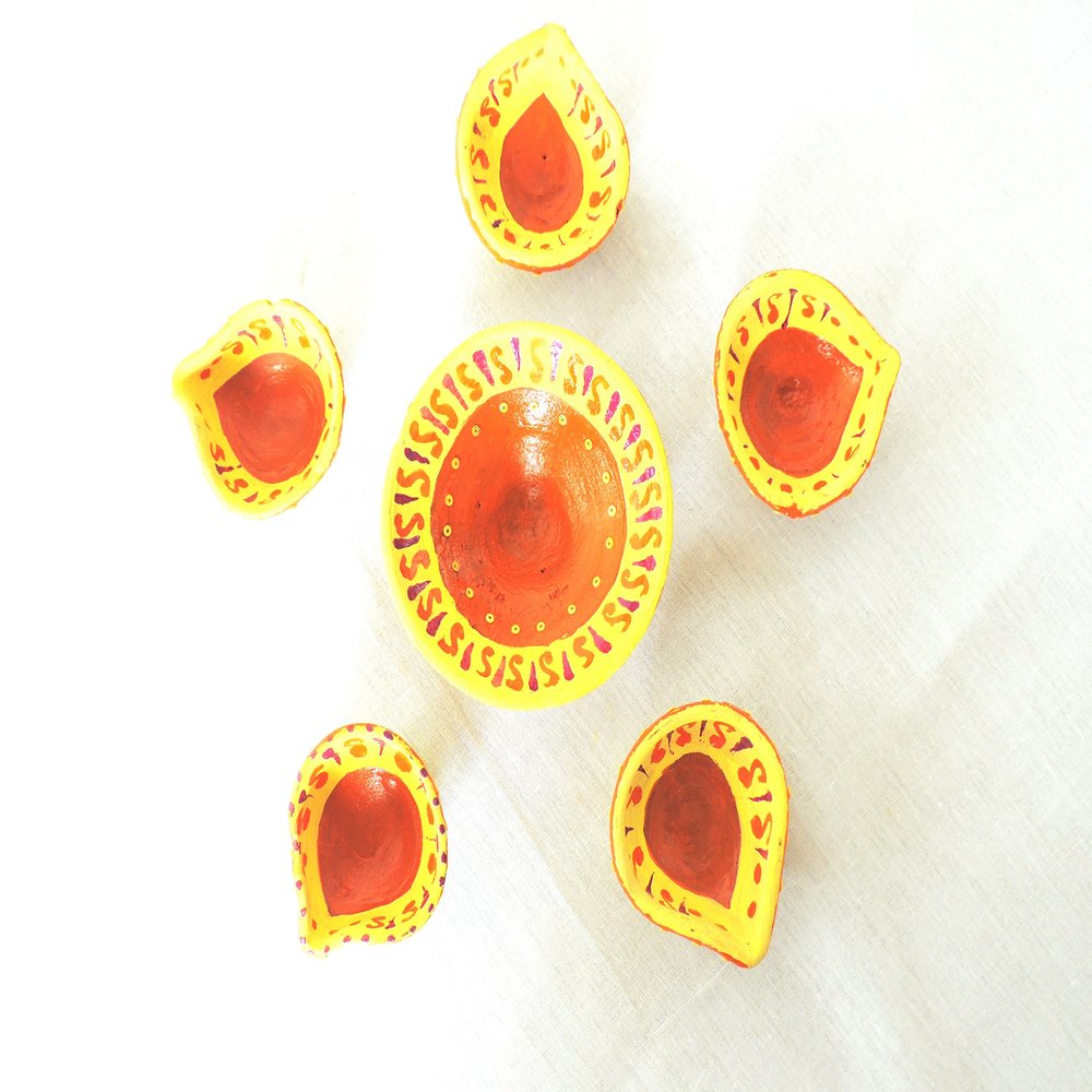 Traditionally decorated earthen diyas with wick