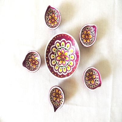 Traditionally decorated earthen diyas with wick