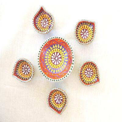 Traditionally decorated earthen diyas with wick