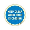 buysafetyposters.com - Keep Clear When Door is Closing Glow Sign - Glow In Dark Eco Vinyl Sticker - 300 mm DIA view 1
